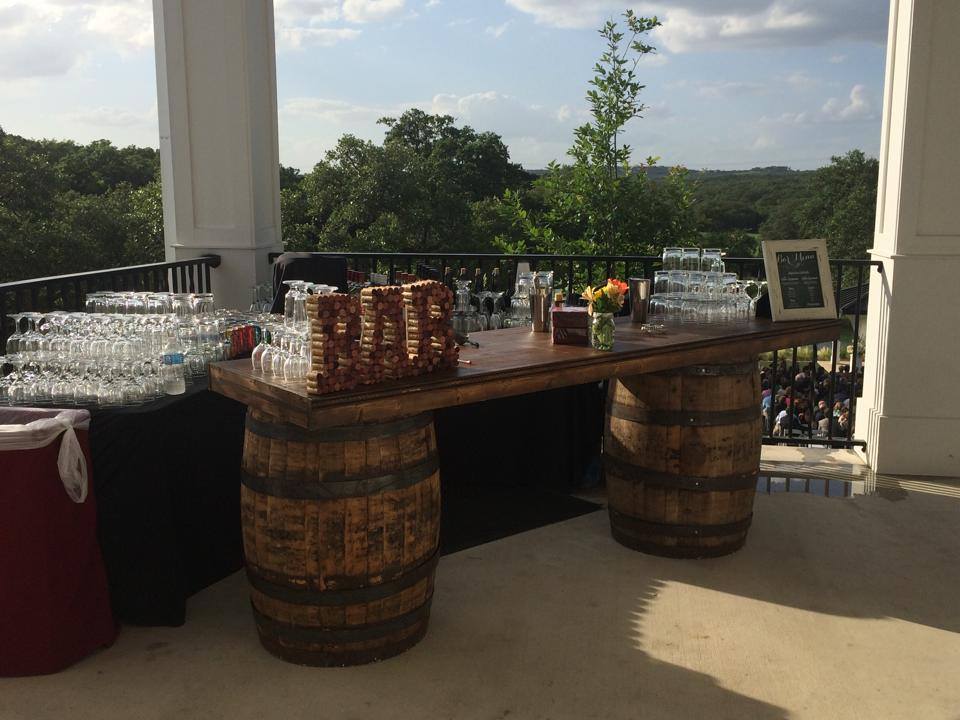 bar on porch made of whiskey barrels
