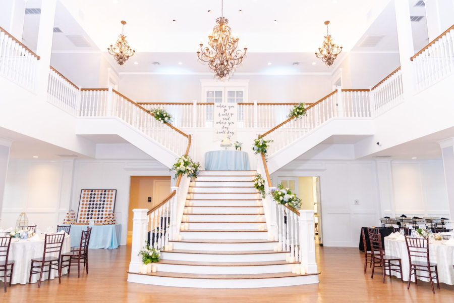 The staircase in the Kendall Point Grand Ballroom decorated with flowers from the ceremony.