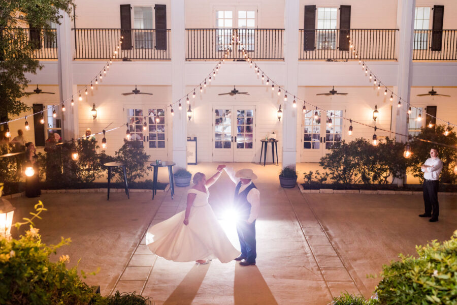 bride and groom having a private dance on the outdoor terrace under string lights