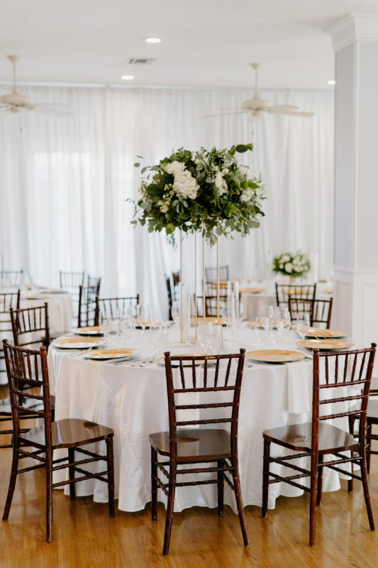 Tall, white and gold centerpieces at a Kendall Point fall wedding reception.