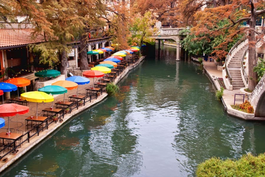 The San Antonio River Walk with brightly colored umbrellas.
