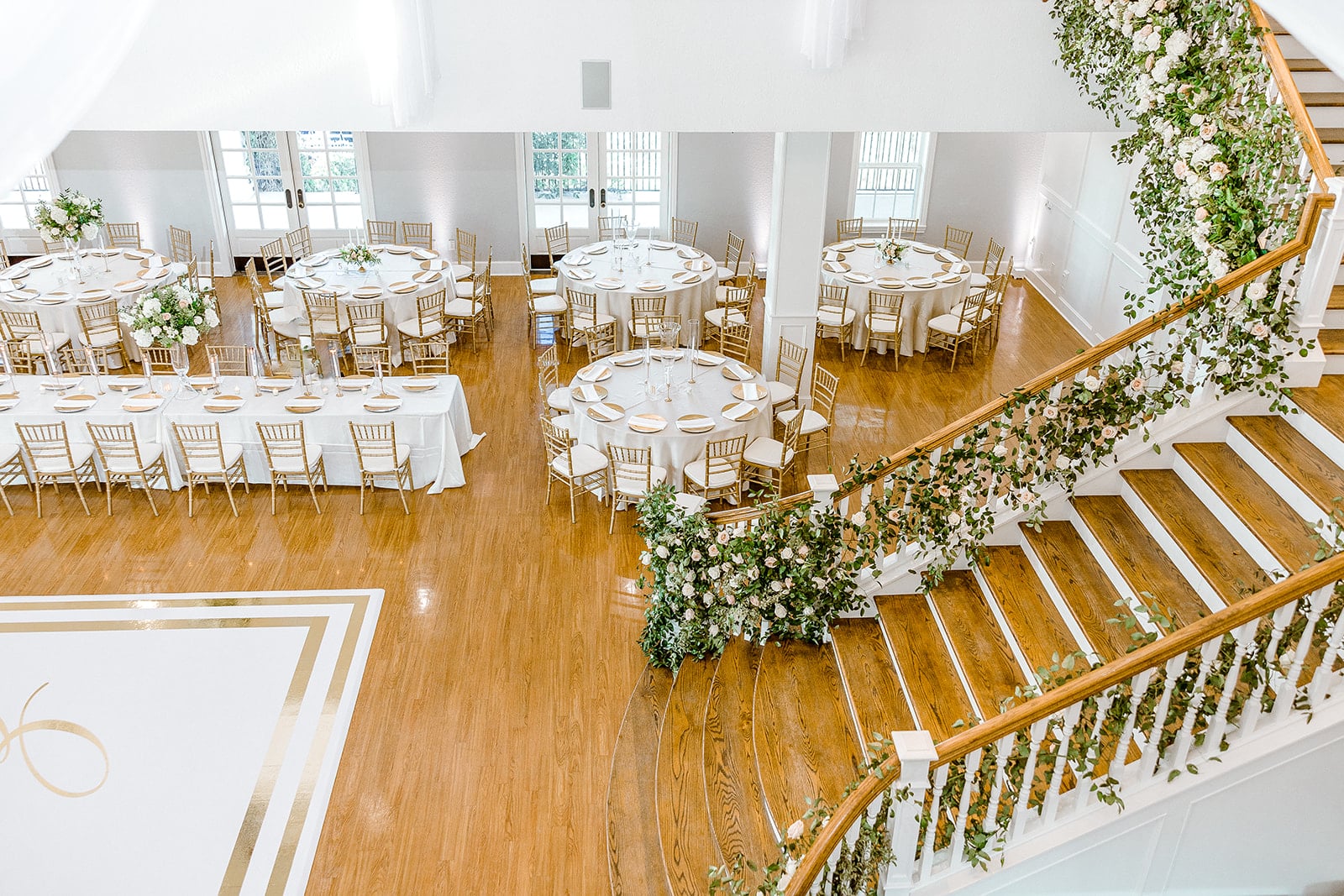 Kendall Point’s staircase decked with florals for wedding reception