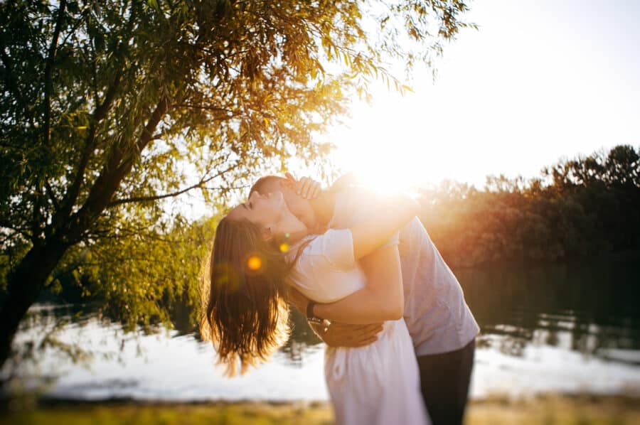 Engaged couple embrace during sunset for their engagement photos.