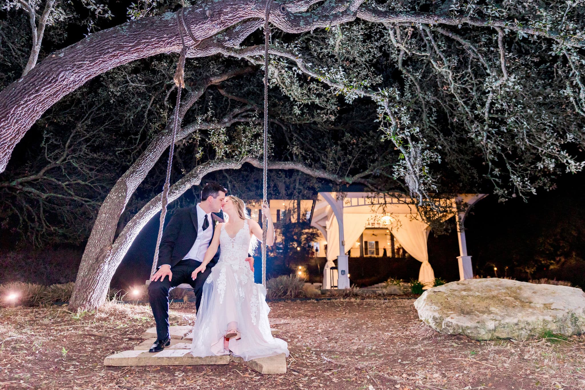 bride and groom kissing on tree swing at Kendall Point