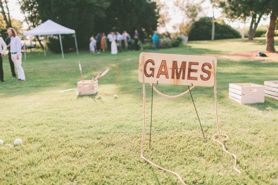 Lawn sign that says "games" at an engagement party.