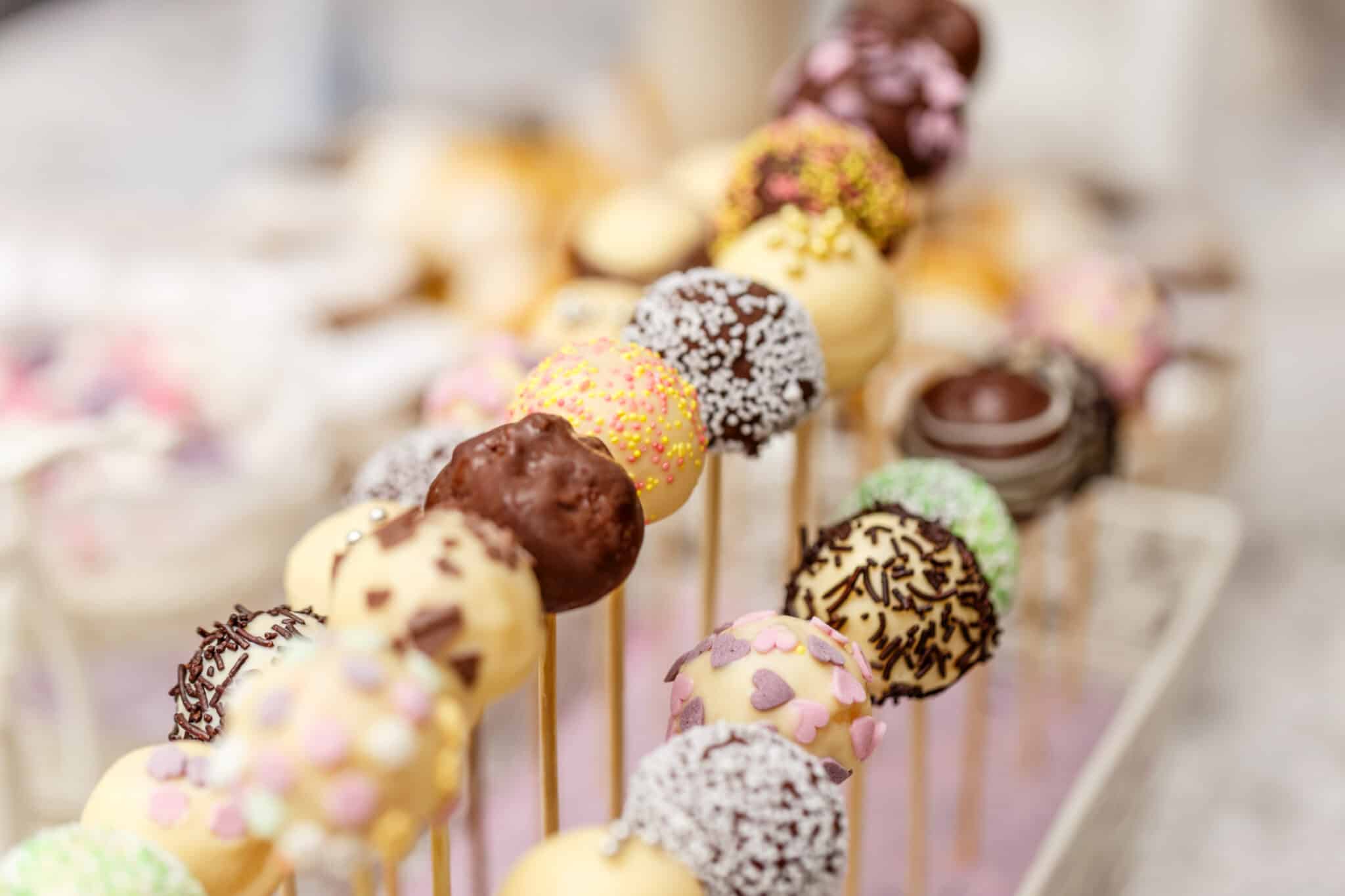 row of cake pops on display at a wedding