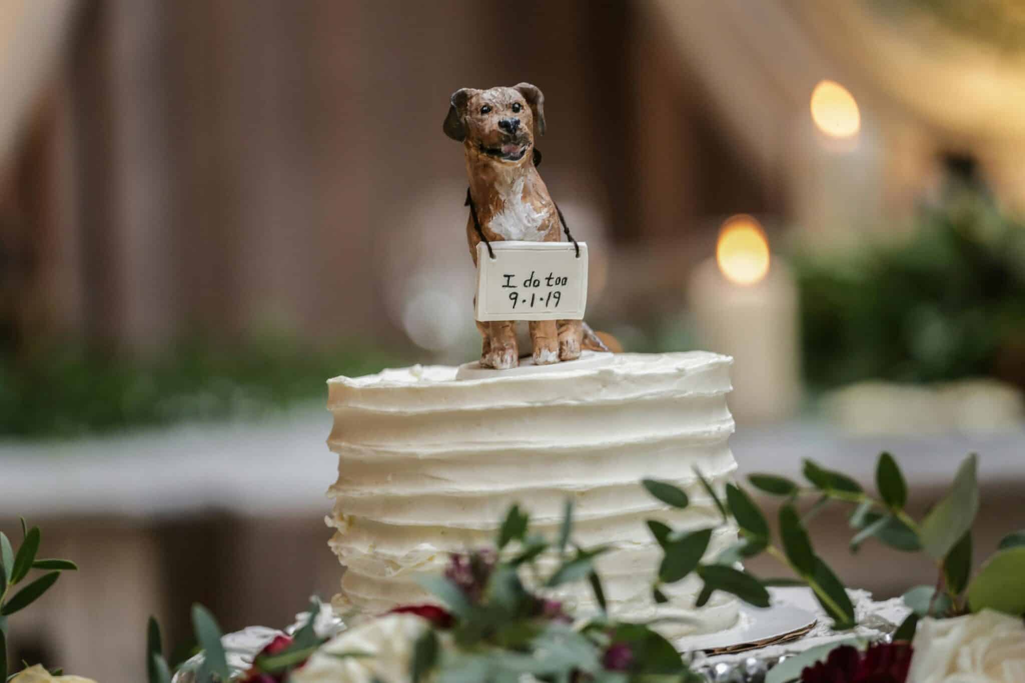 closeup of wedding cake topper shaped like a dog