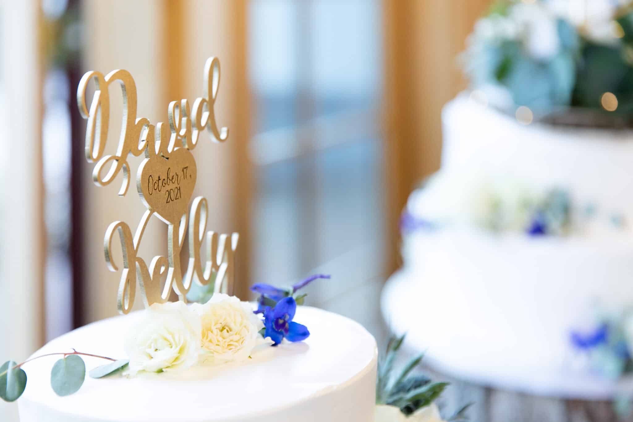 Closeup of wedding cake topper featuring couple's names