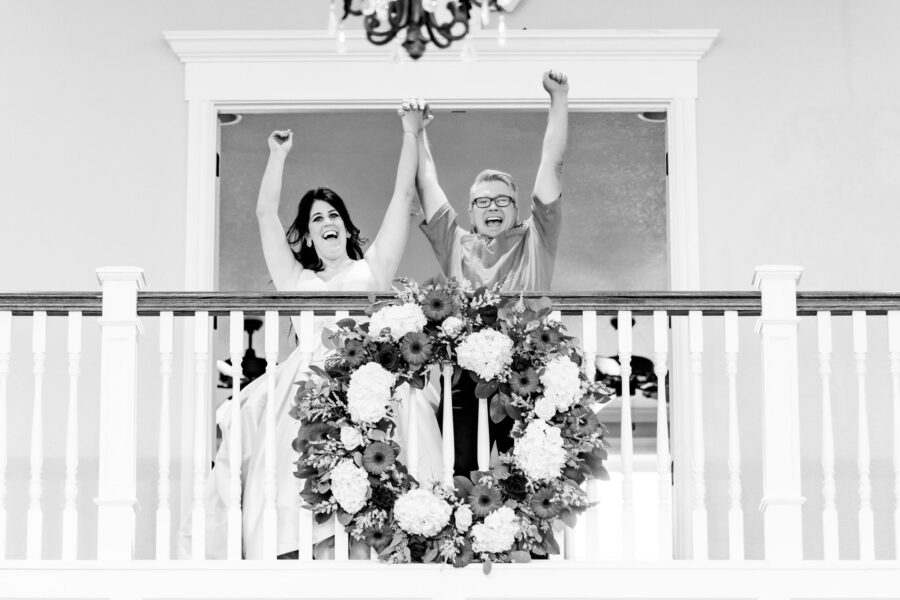 A bride and groom celebrate on the Kendall Point balcony.