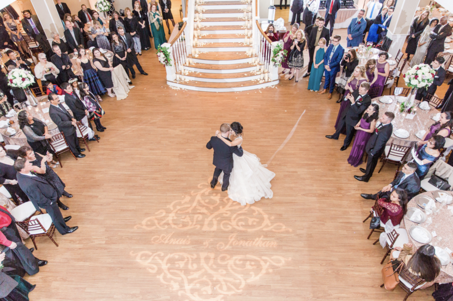An aerial photo of a bride and groom's first dance in the ballroom.