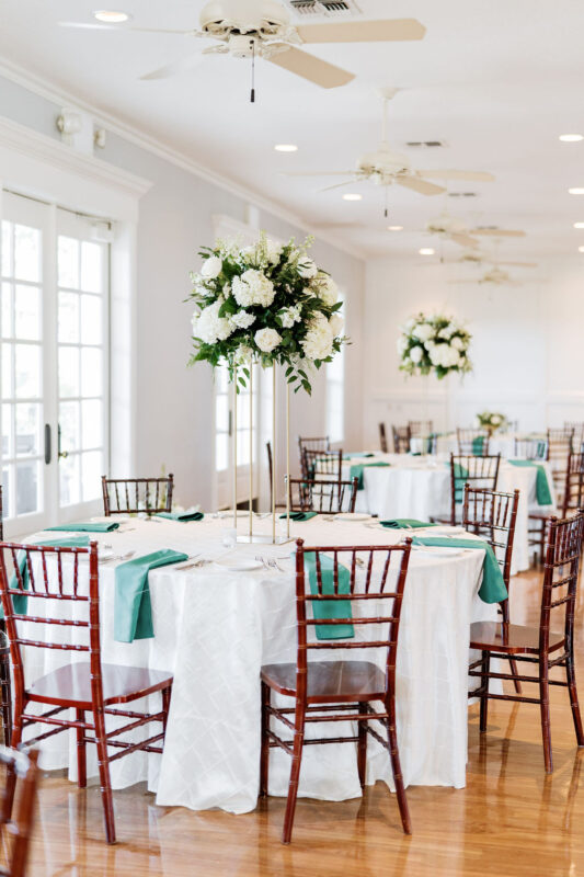Tall green and white floral centerpieces. 