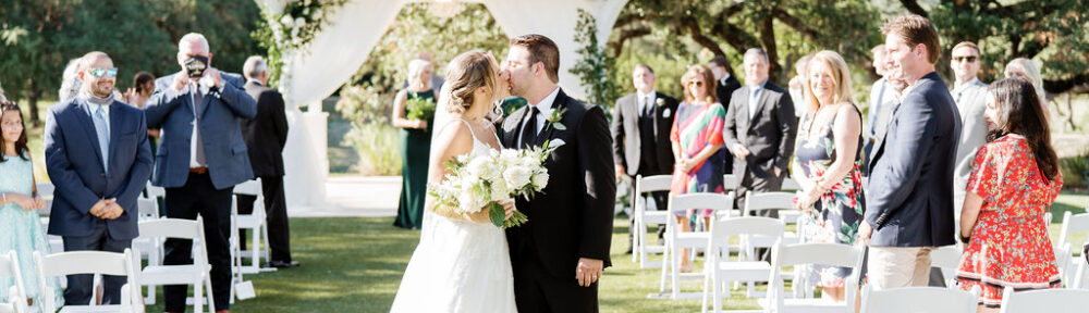Bride and groom kiss following wedding ceremony
