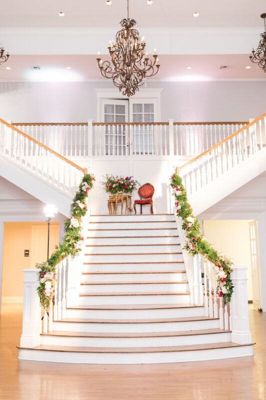 Soft pink lighting makes for a romantic staircase in the Kendall Point Grand Ballroom.