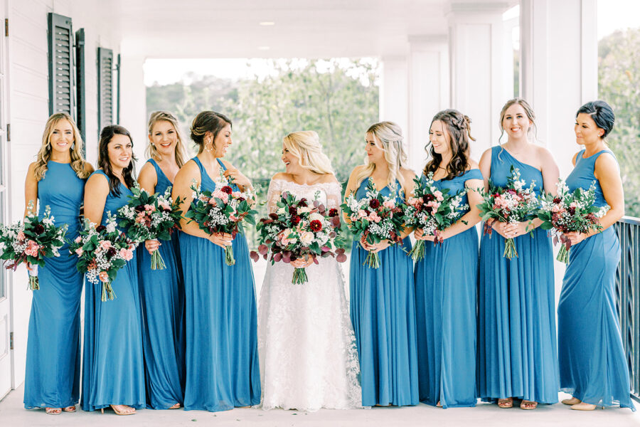 Bride posing with her bridesmaids on Kendall Point veranda