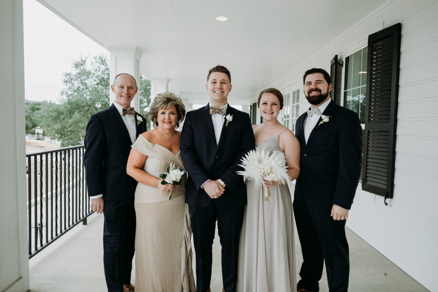 The groom poses for a photo with his immediate family. 