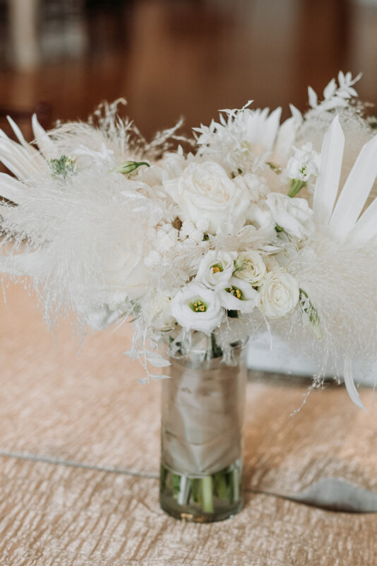 White floral and feathered centerpieces.