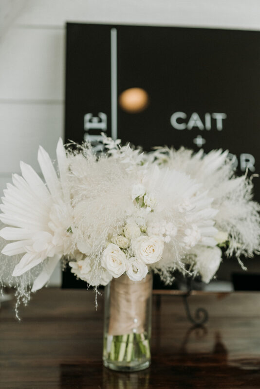 White floral and feathered centerpieces. 