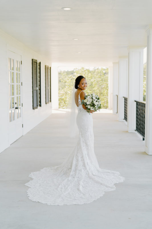 A bride poses on the Kendall Point balcony.