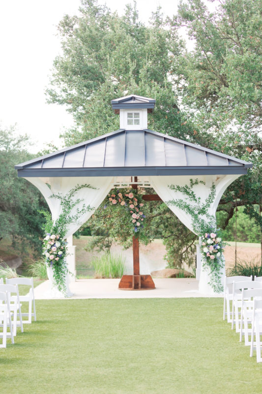 Cedar cross and Kendall Point gazebo adorned with pink and blue flowers