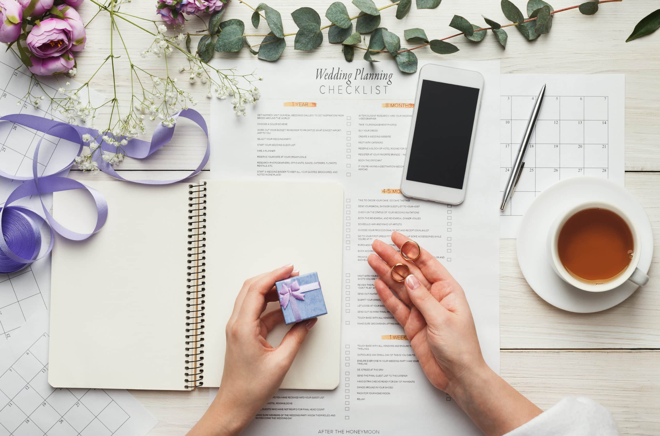 A day of coordinator looking over a wedding planning checklist.