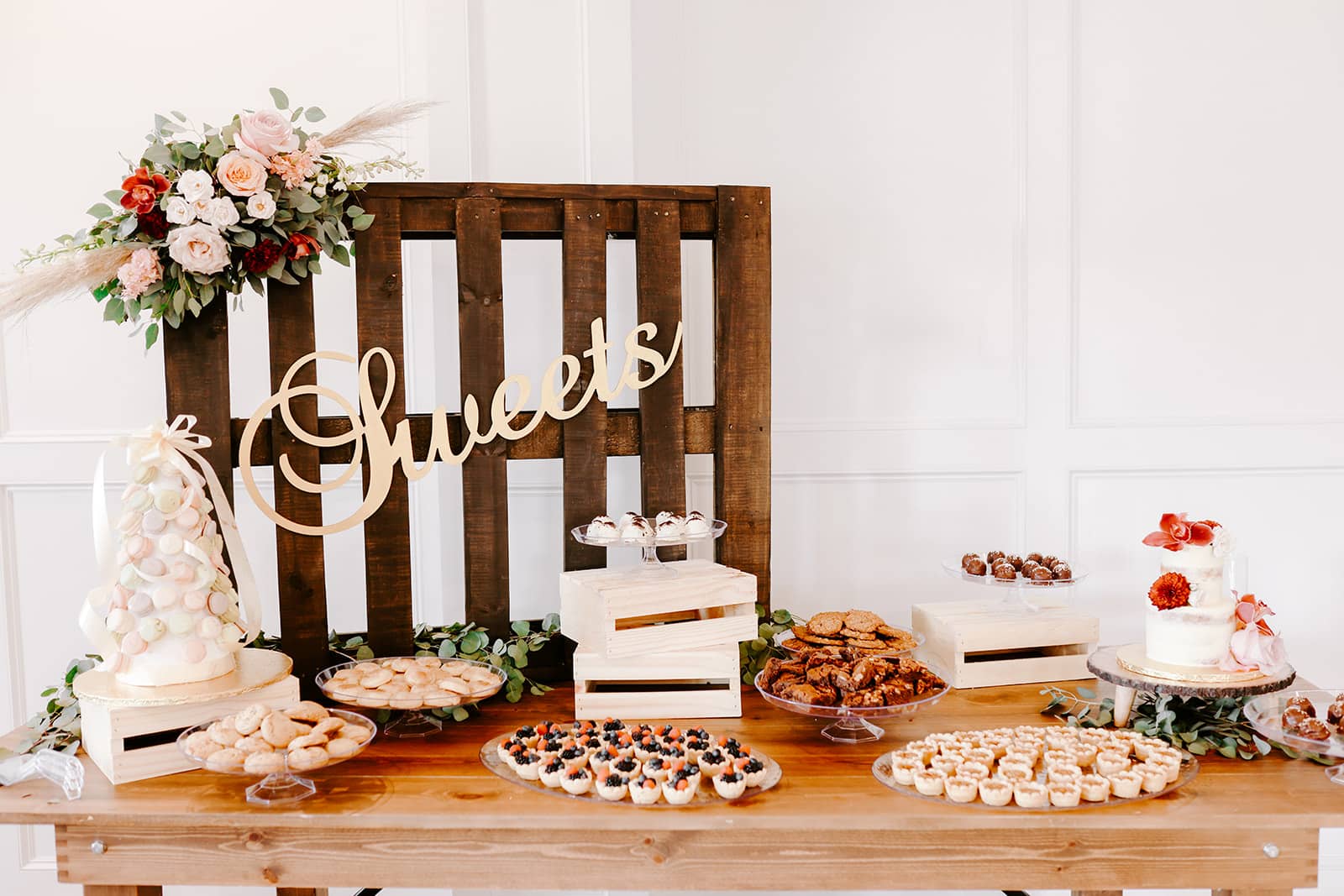 Dessert table at wedding covered in treats