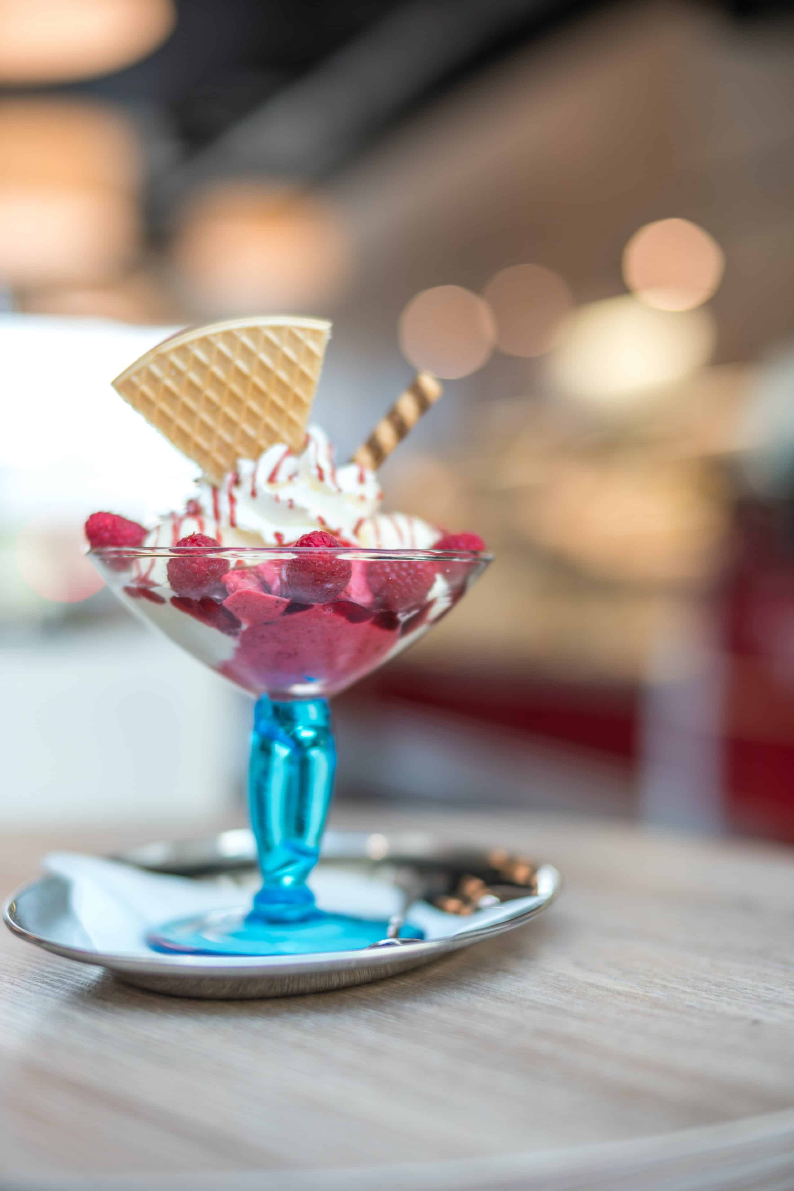 elegant ice cream dish with raspberry sorbet and toppings