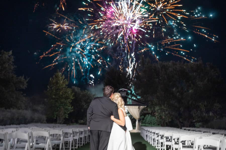 Newlyweds Kendall & John watch the fireworks show at their Kendall Point wedding