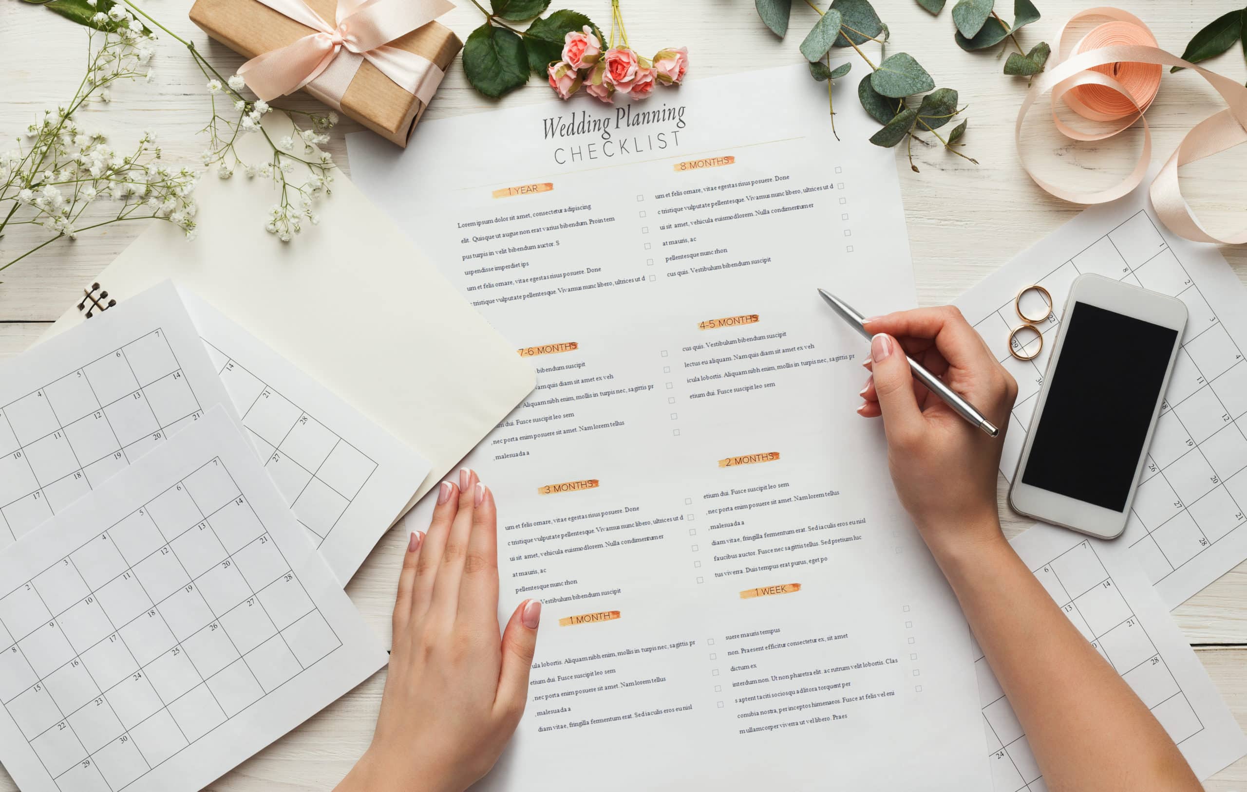 A wedding planner looks over an extensive wedding planning checklist.