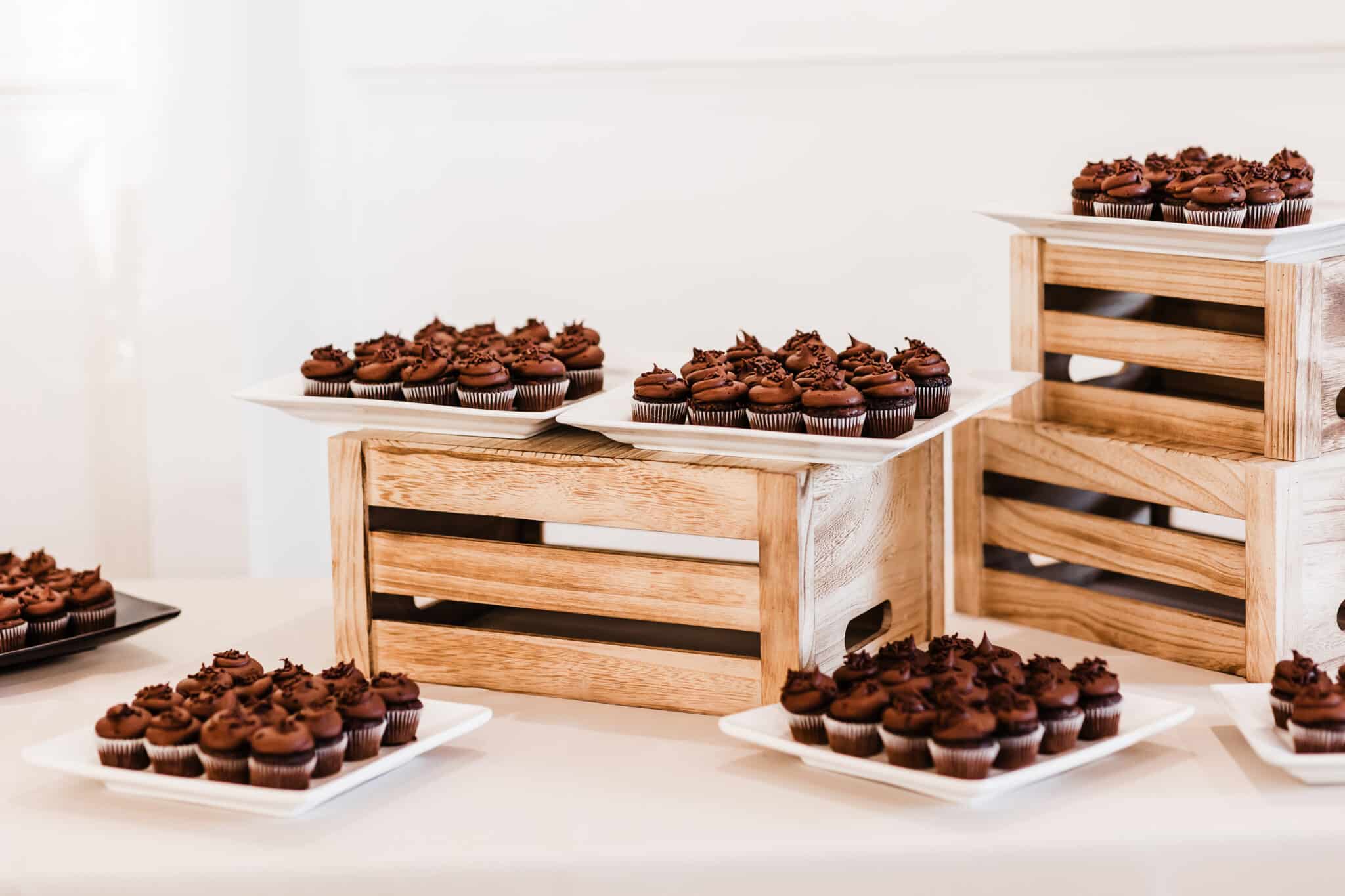 Chocolate cupcakes displayed on wooden boxes