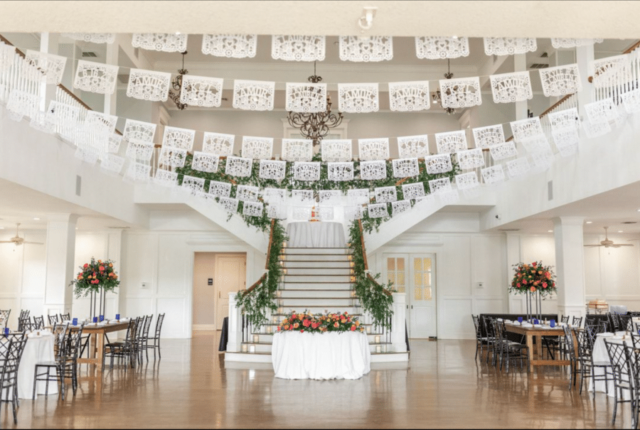 White papel picado decorations hang in the Kendall Point ballroom