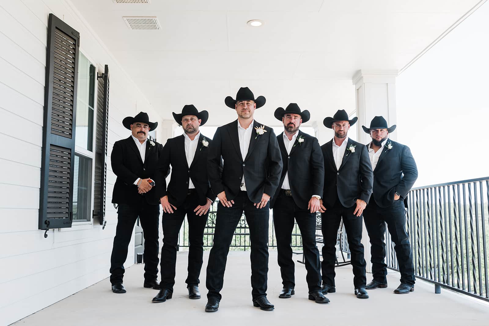 Groom with groomsmen wearing cowboy hats