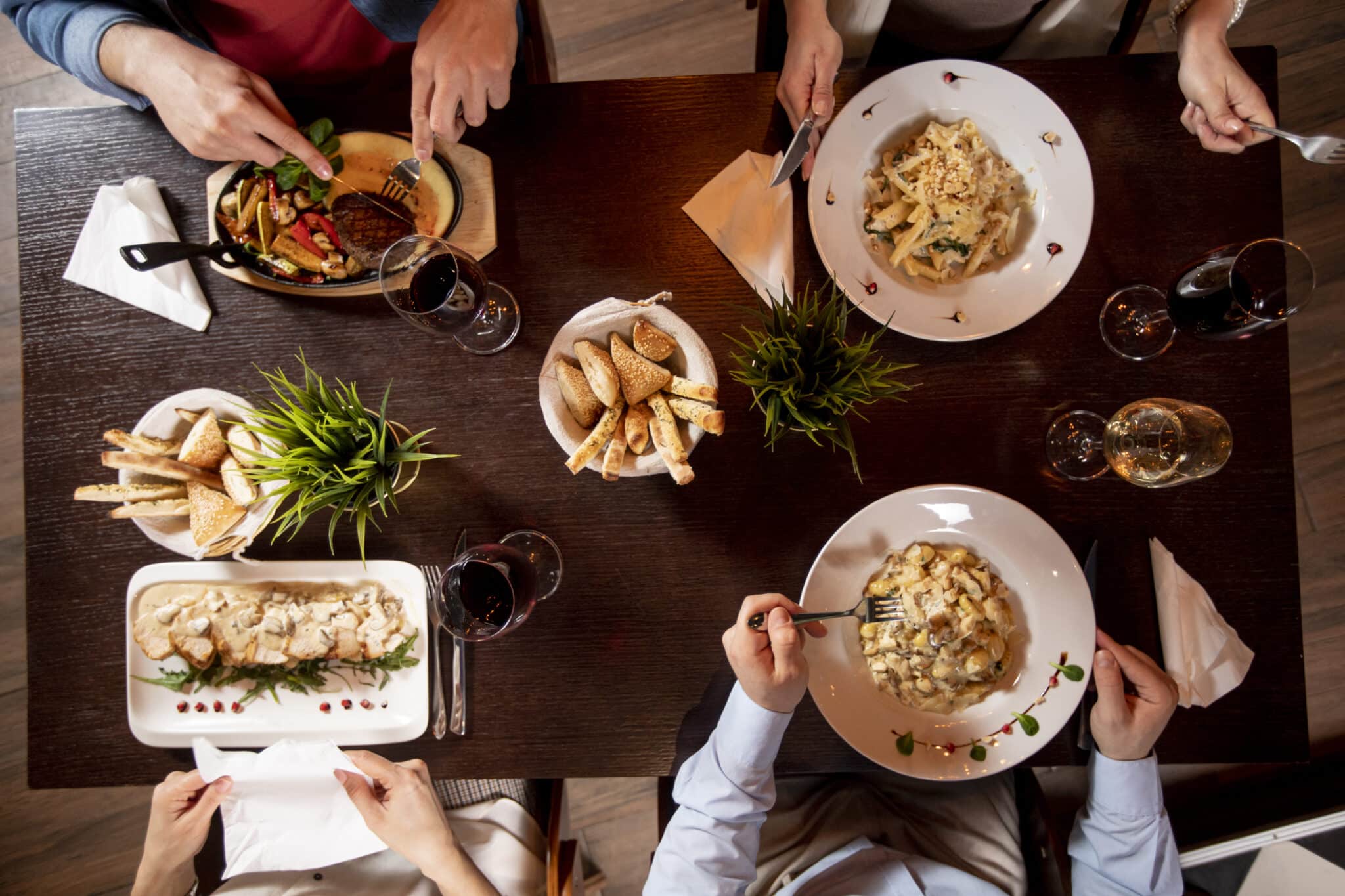 Group of young people having dinner in the restaurant