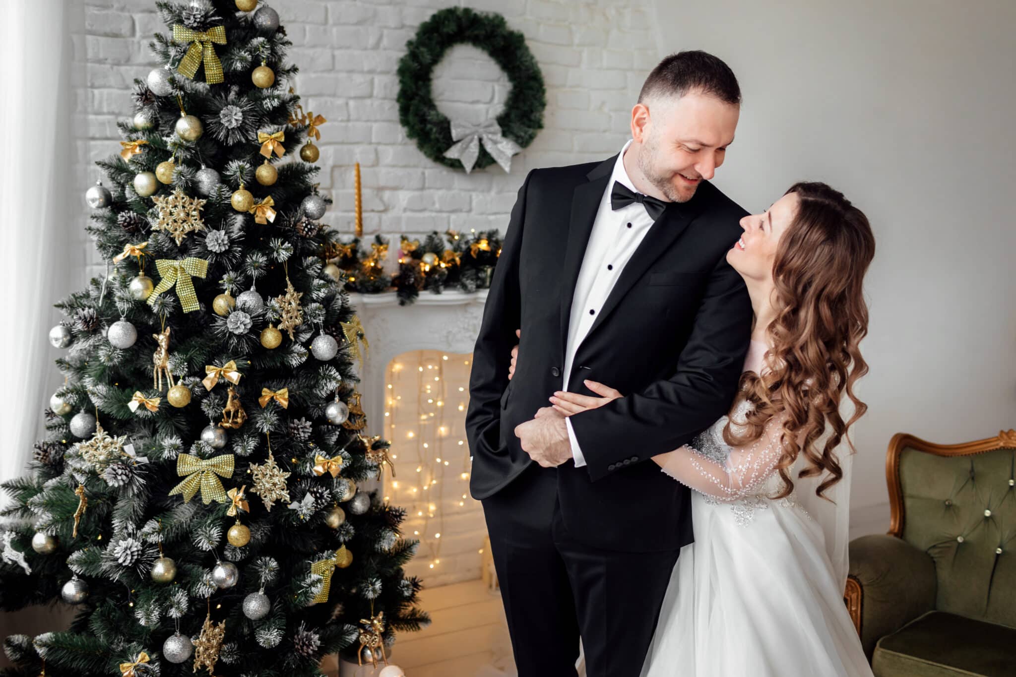 Bride and groom in room decorated for Christmas