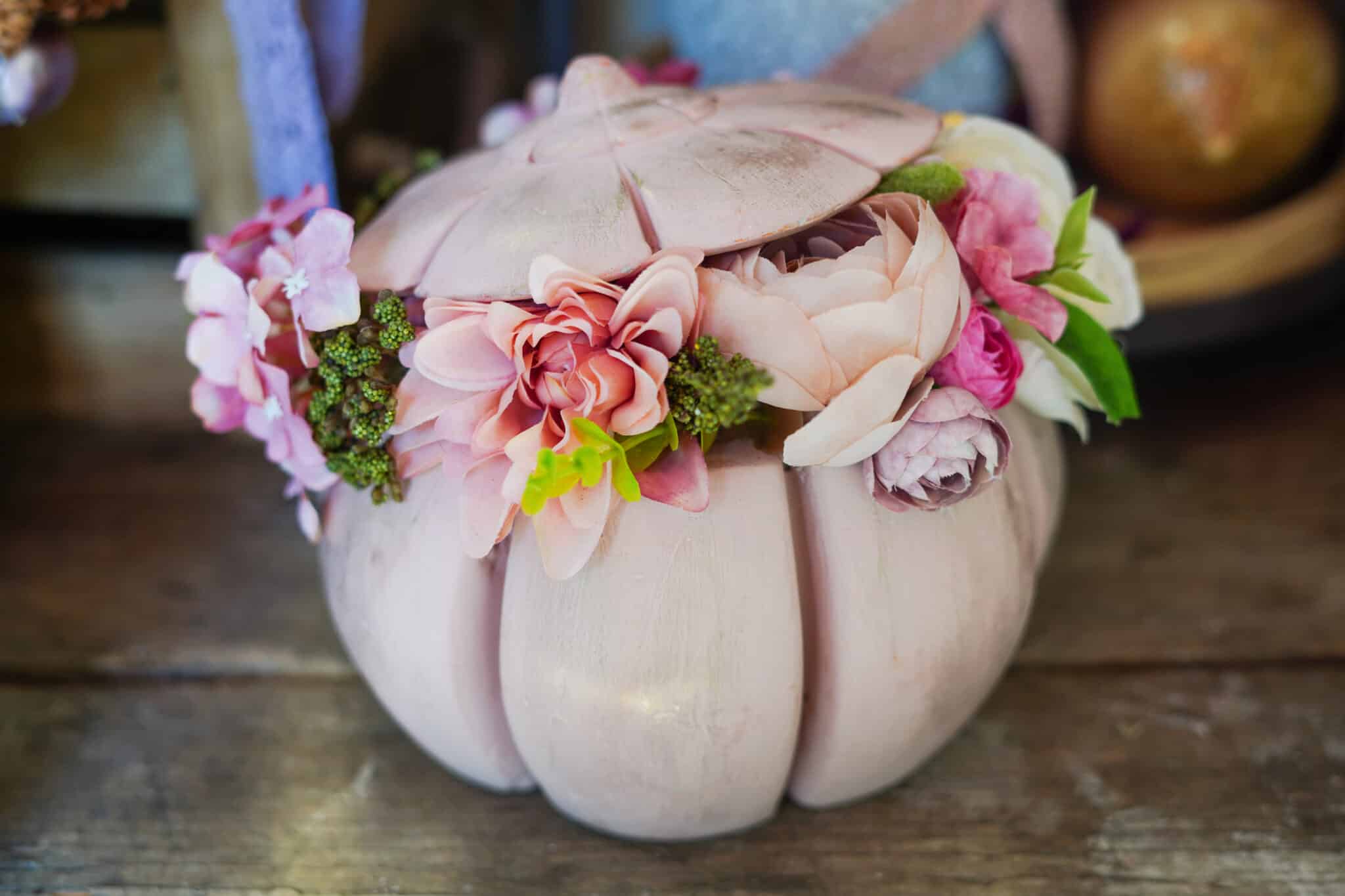 Floral arrangement inside of decorative pumpkin