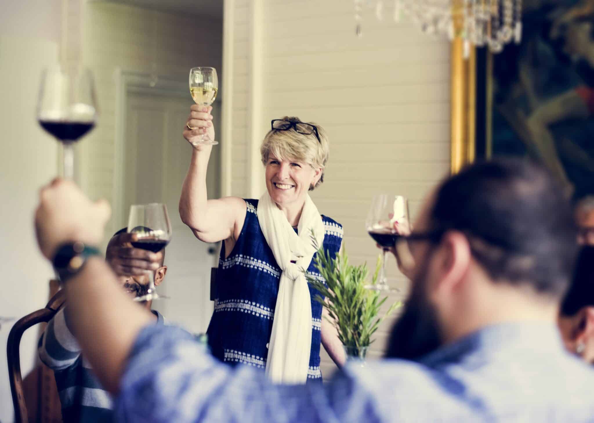 woman giving a toast at rehearsal dinner