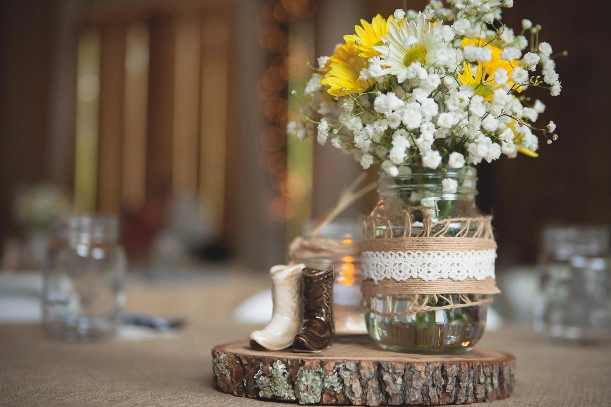 Rustic wedding centerpiece with wood and burlap