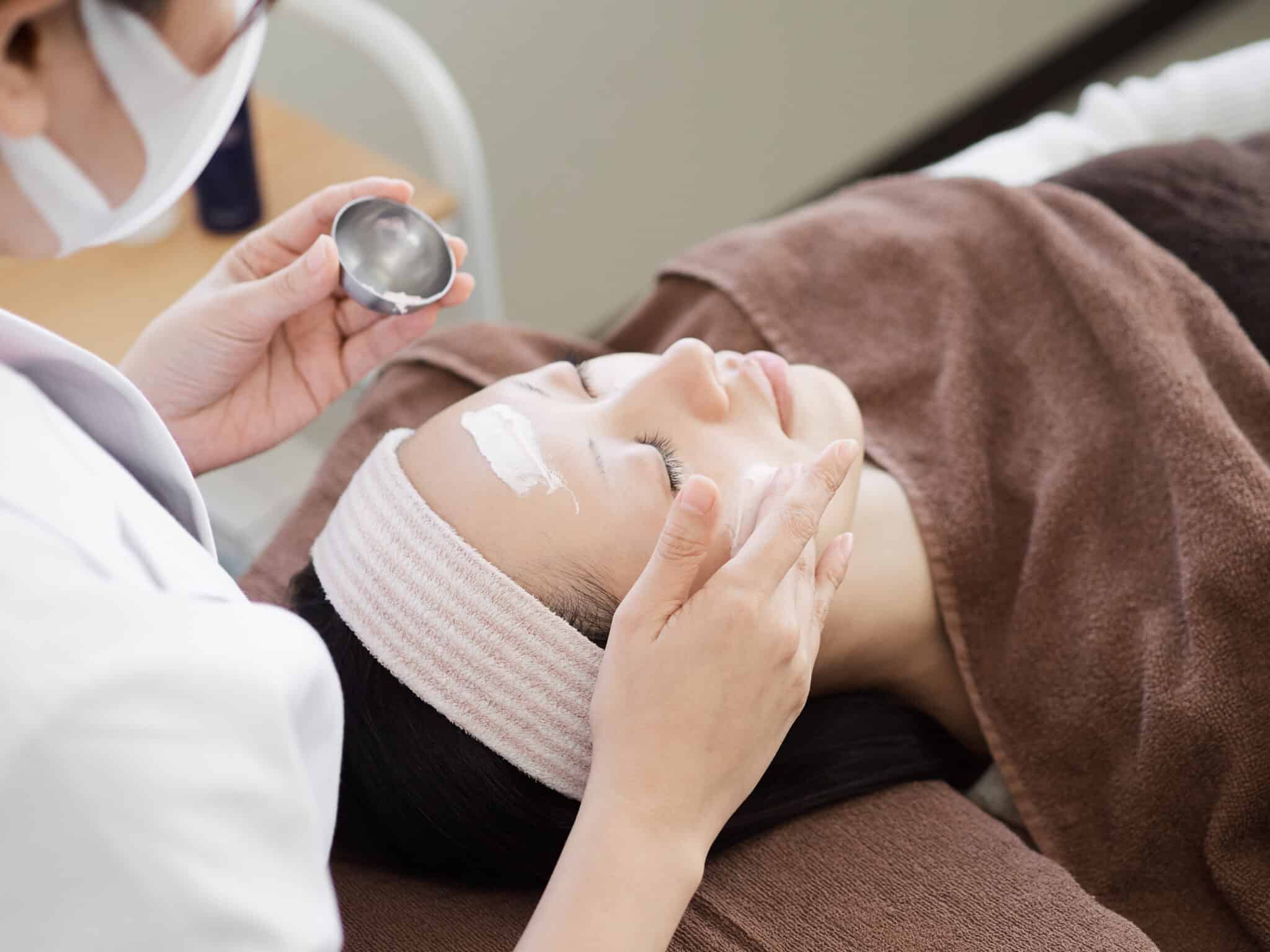 woman receiving a facial at a spa