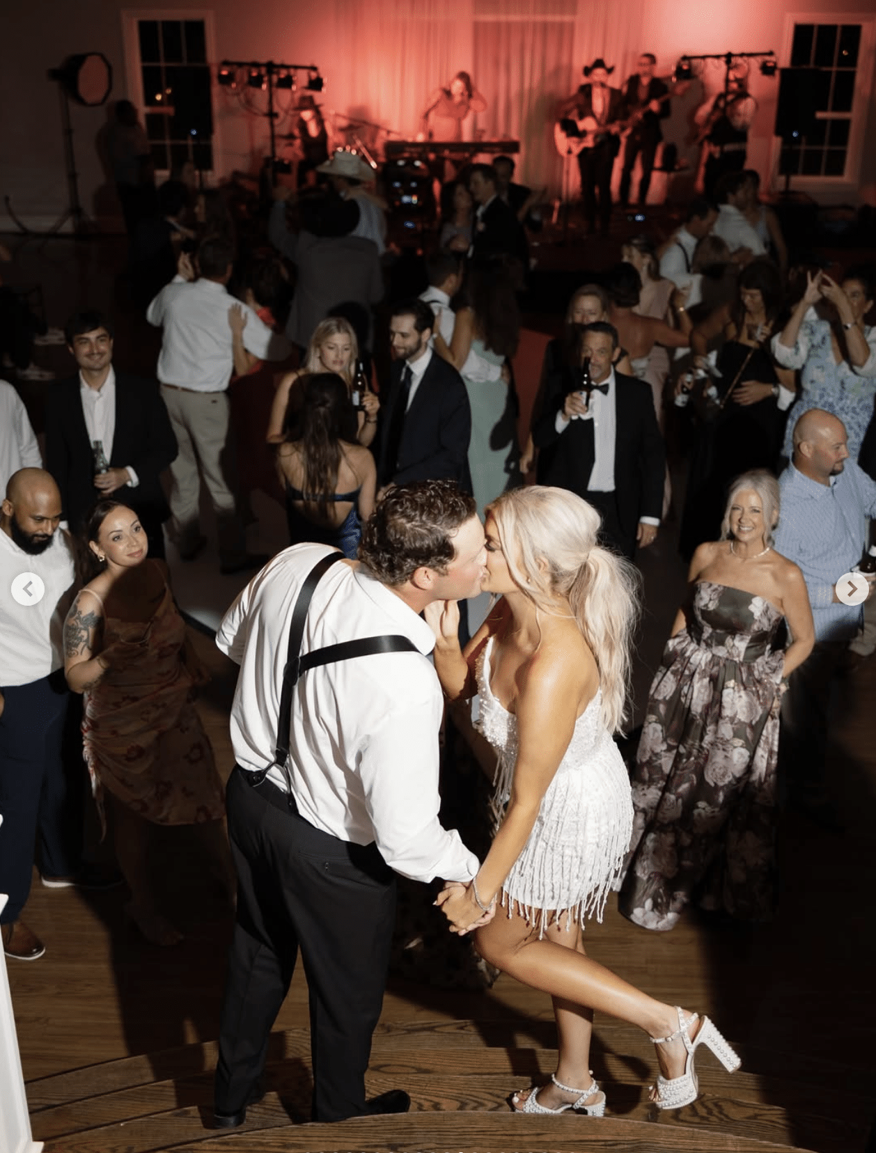 dance floor photo of bride and groom kissing
